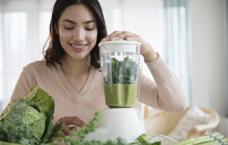 woman making a green drink