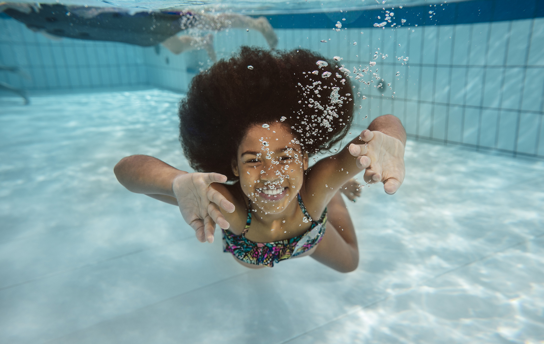 AltaMed little girl swimming under water