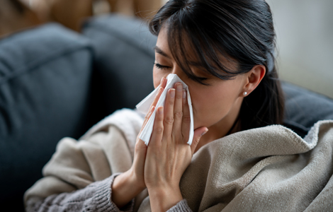 woman blowing her nose