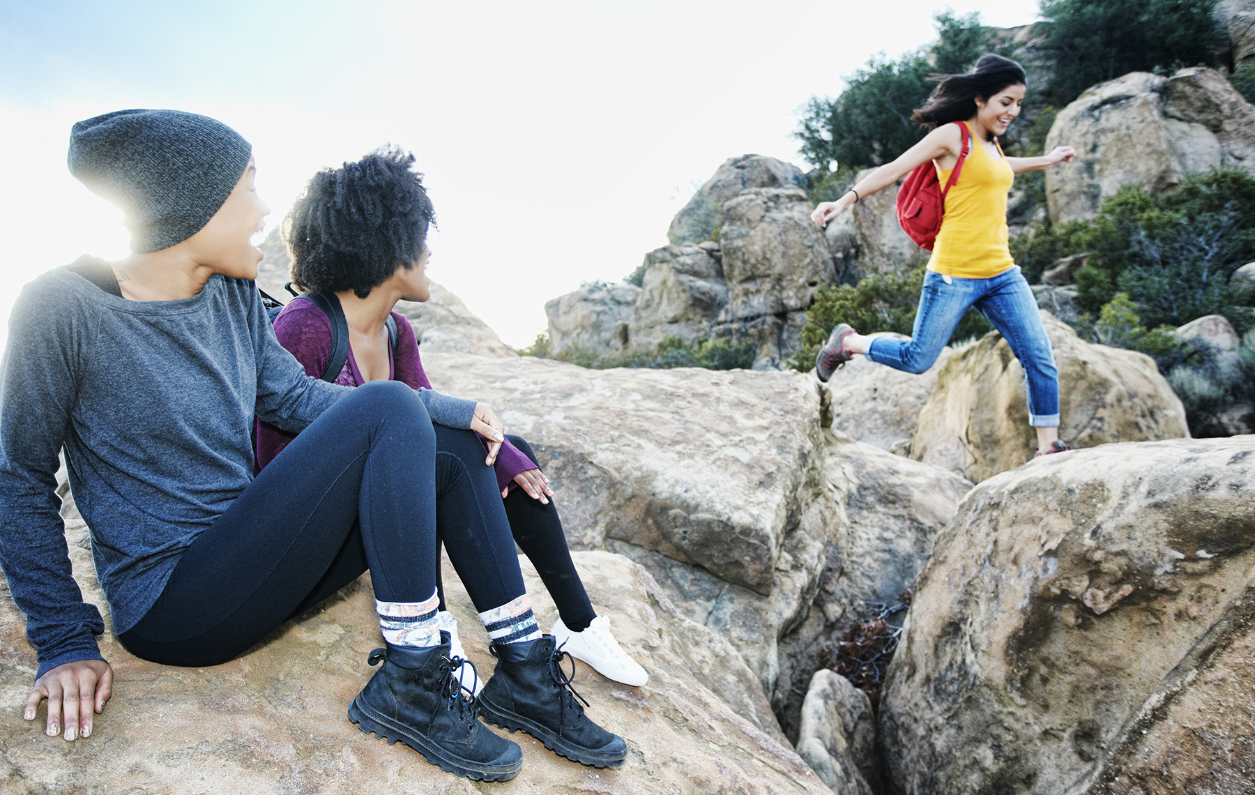 AltaMed three people jumping on rocks having fun