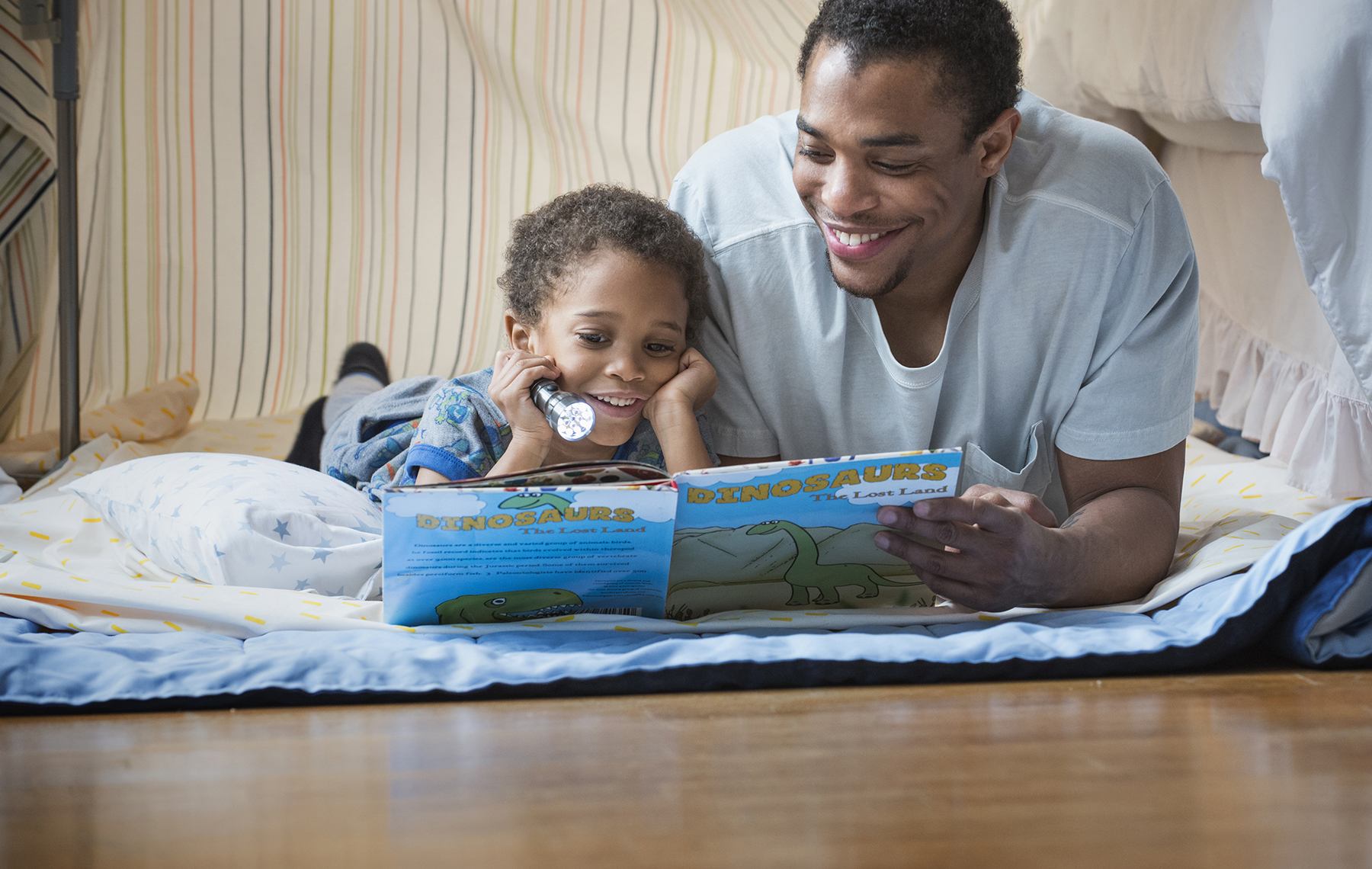 AltaMed dad and daughter reading together